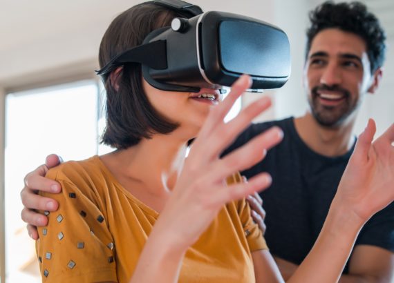 A man guides a woman in a social VR platform.