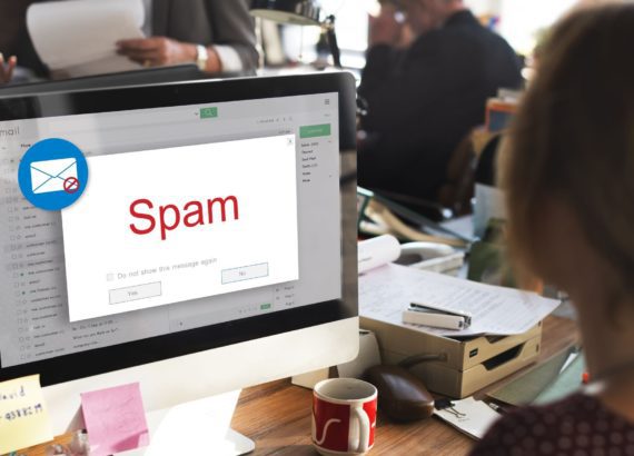 Woman checks her email, only to find it full of spam emails.