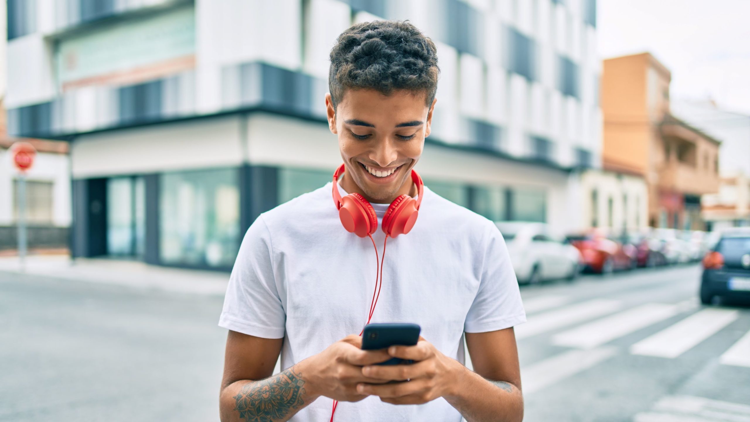 A young man checks his social media on his smartphone.