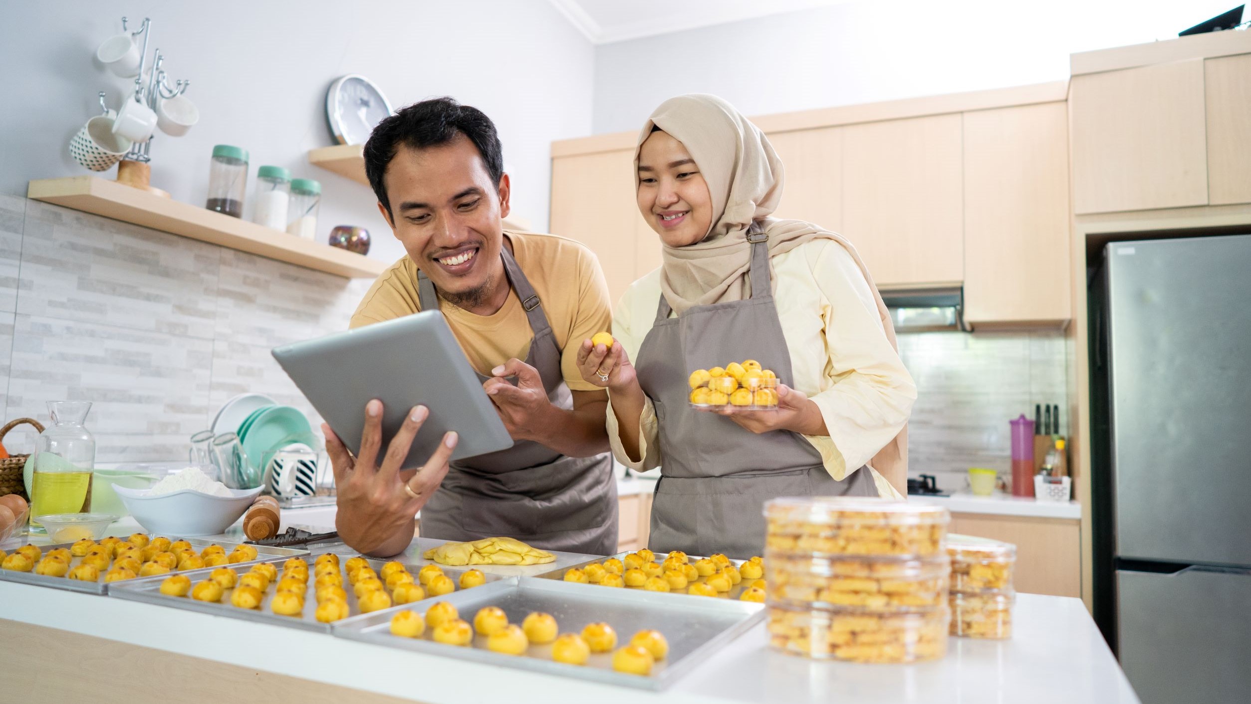 A pair of bakers stream a live YouTube video about their latest product.