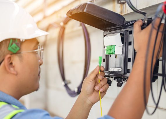 A technician installing a fiber optic cable