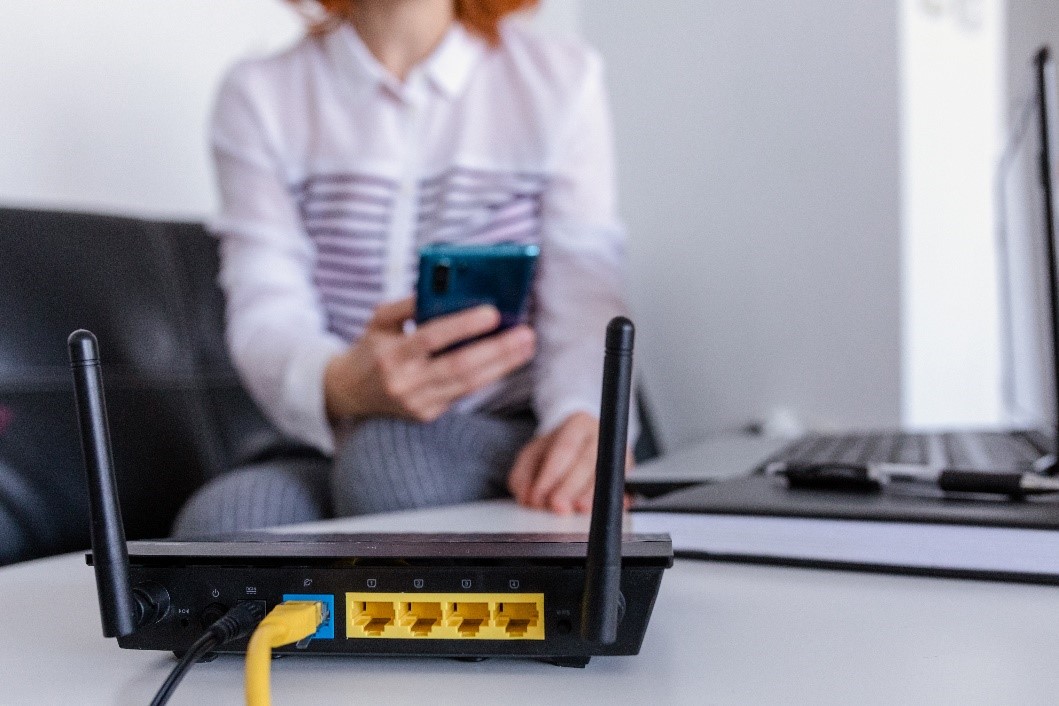 Woman looking at phone, learning how to avoid cybersecurity threats