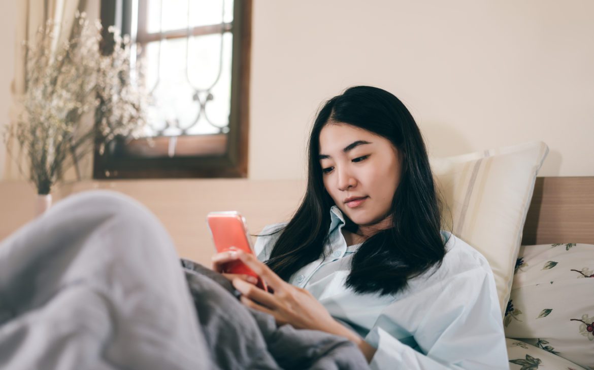 Young woman on her phone, using mental health apps