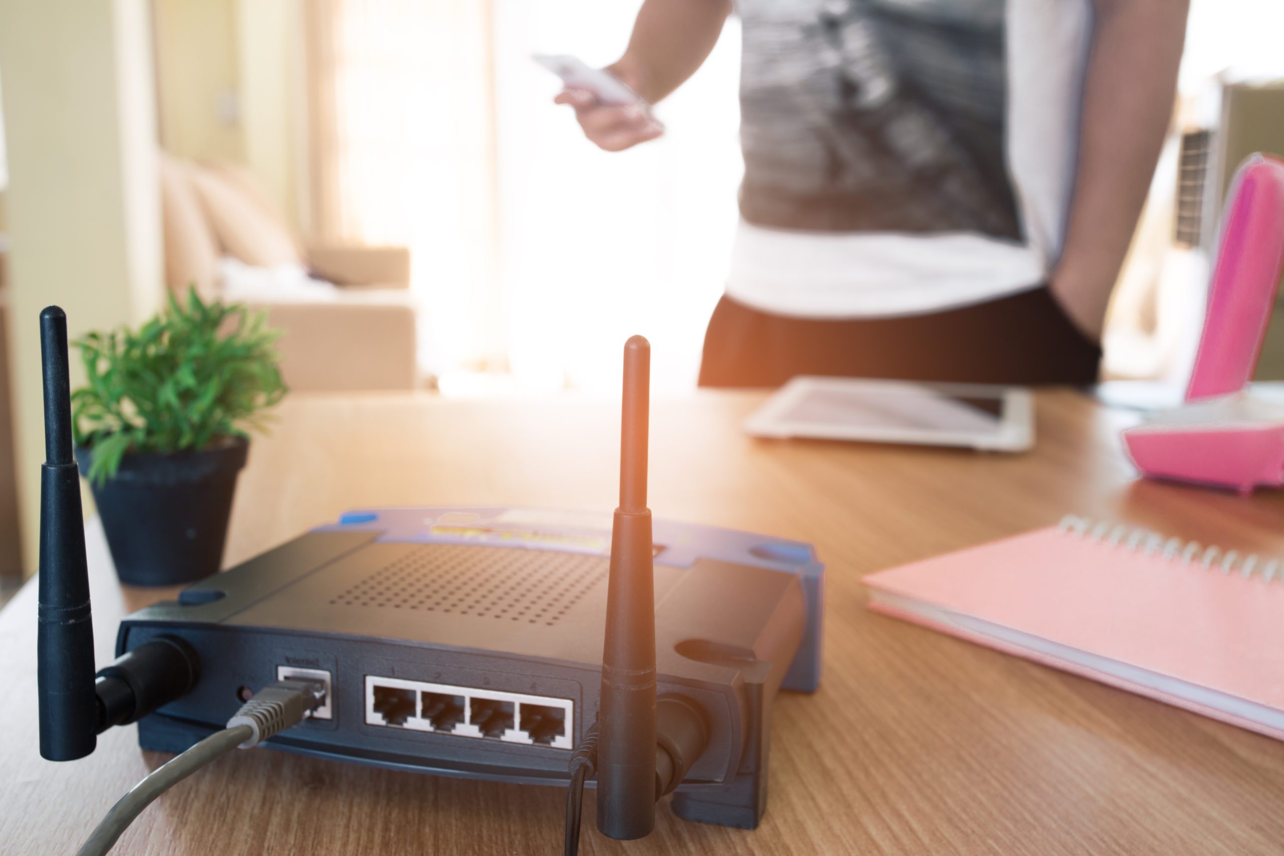 man looking at his phone with modem