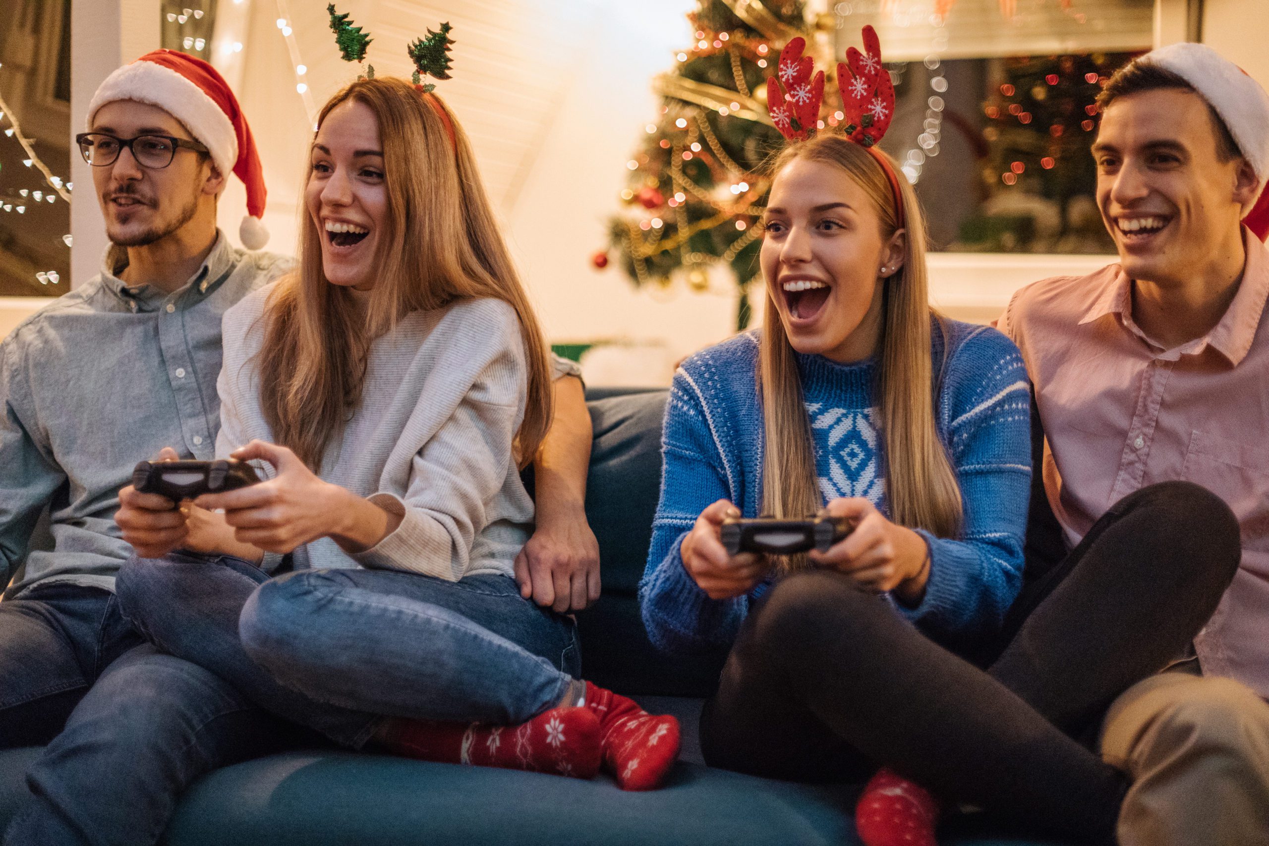 young friends enjoying their cool tech gift, a gaming console