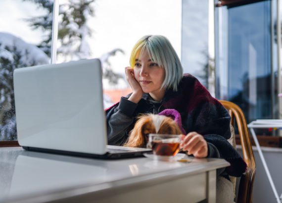 Young girl practicing cold weather safety by staying indoors