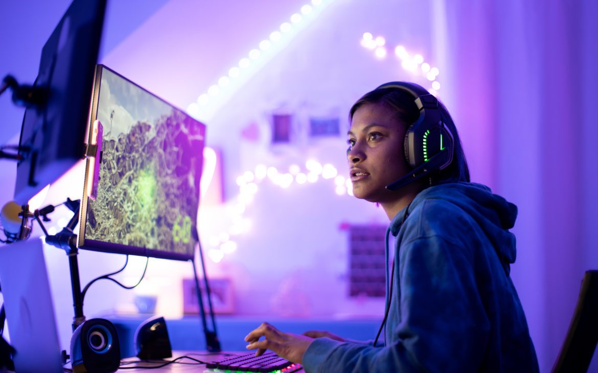 A young woman enjoys internet for gaming.