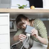 Young woman installing a wireless LAN for small business.