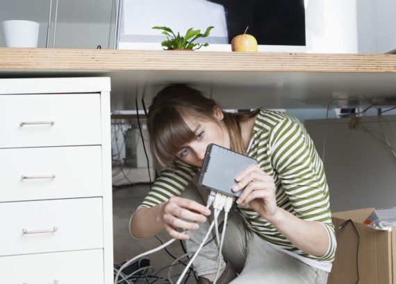 Young woman installing a wireless LAN for small business.