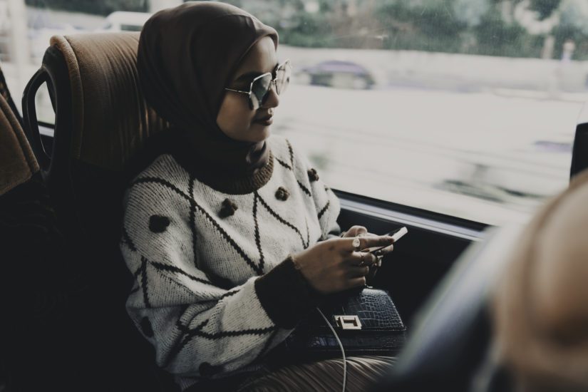 A woman practices social media privacy on the go.