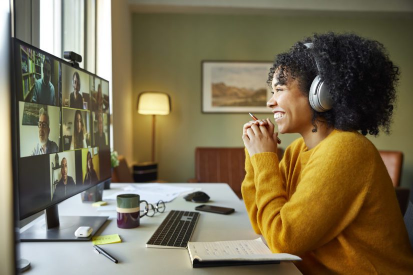 This happy woman doesn't need to wonder "what is a good internet speed for working from home" as she smiles at her remote colleagues! 