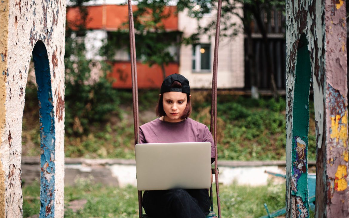 Woman on a swing with laptop