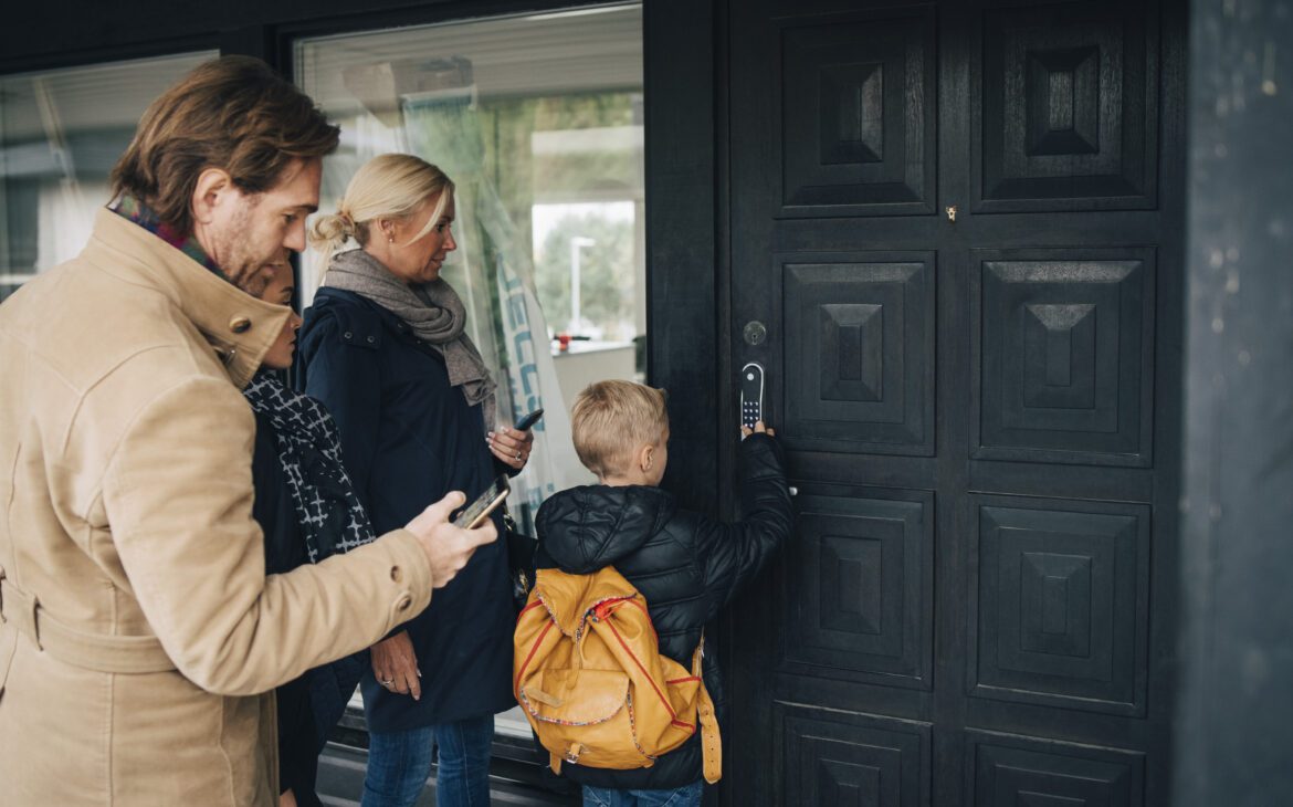 A family uses internet of things security to enter their home with a smart lock device.