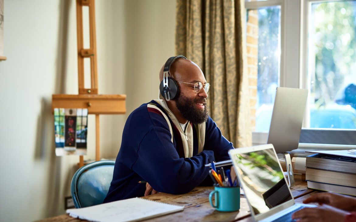Man wearing headphones while using tips for working from home 