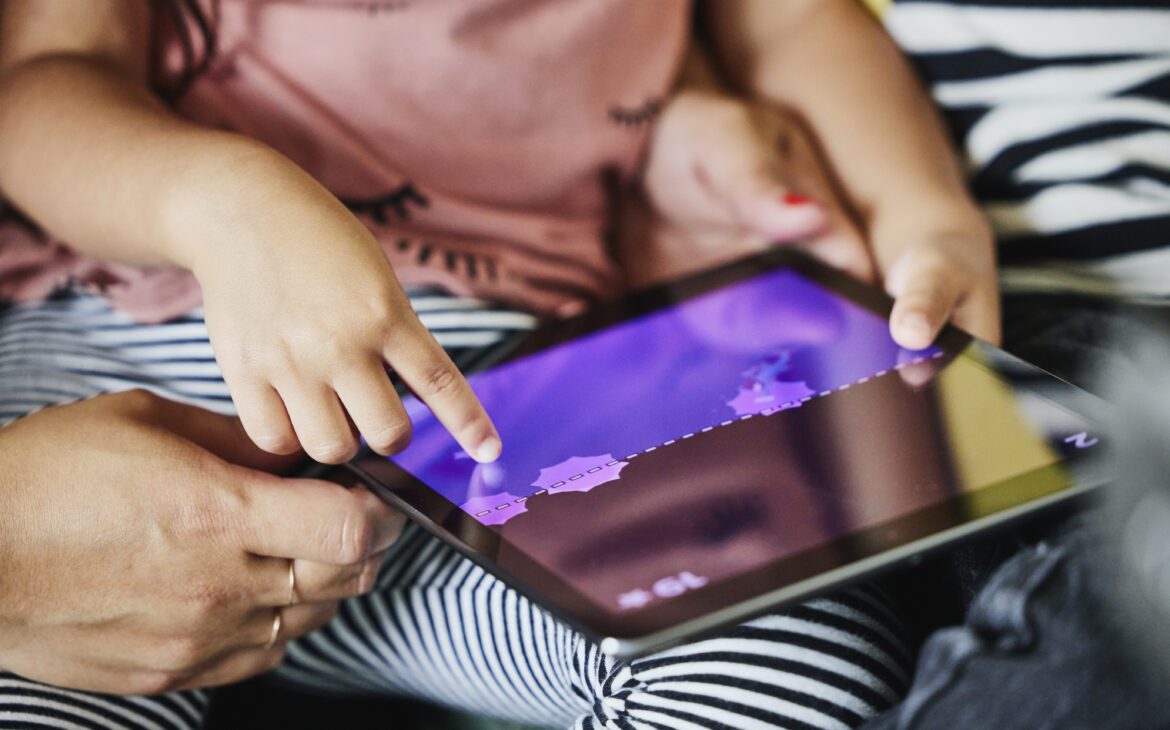Kid playing games on a tablet