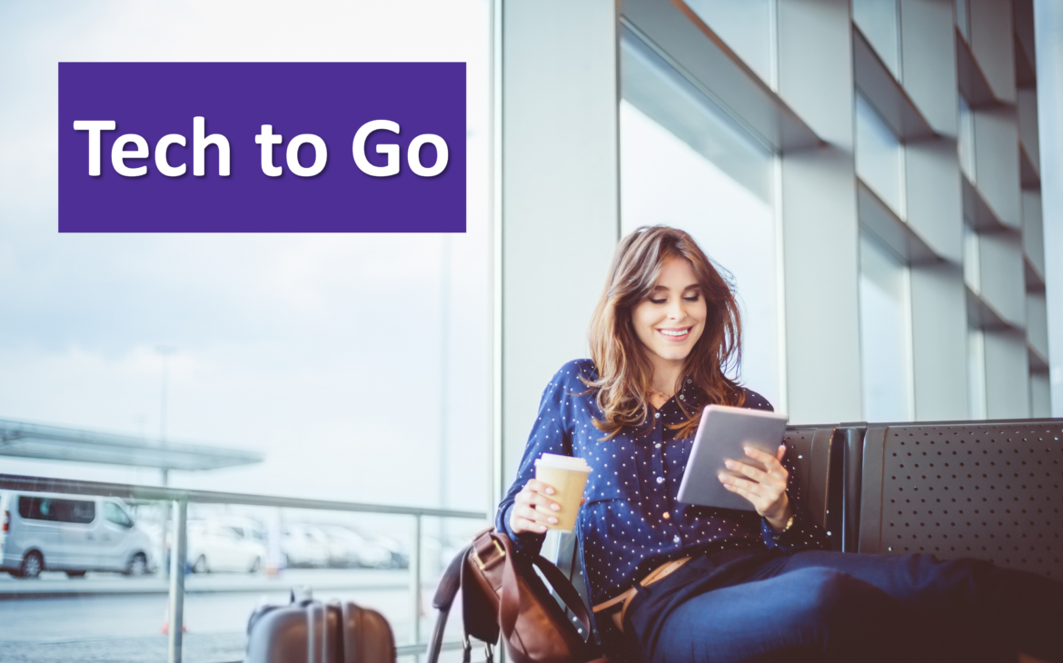 A woman reads an e-reader in an airport