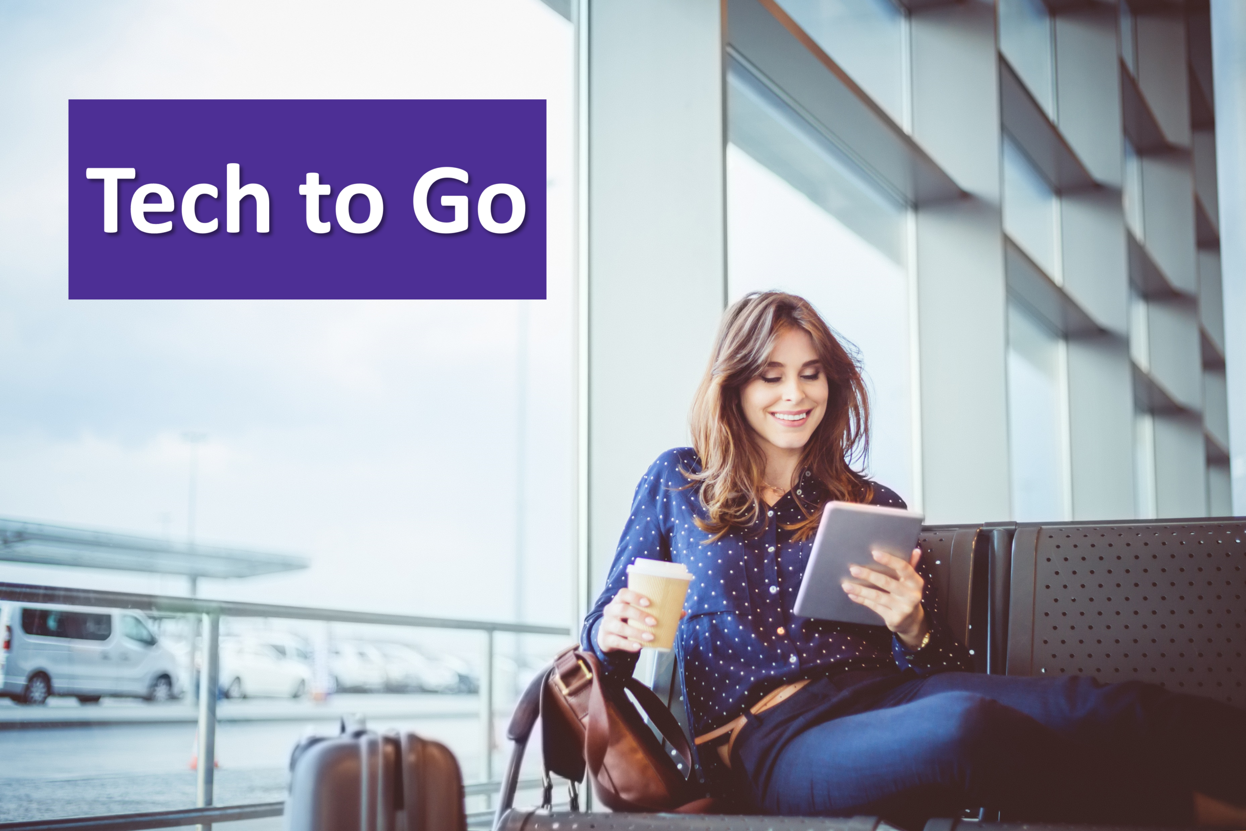 A woman reads an e-reader in an airport