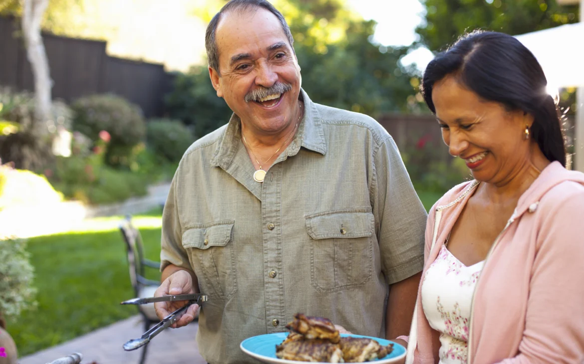 A man grills using a wireless meat thermometer