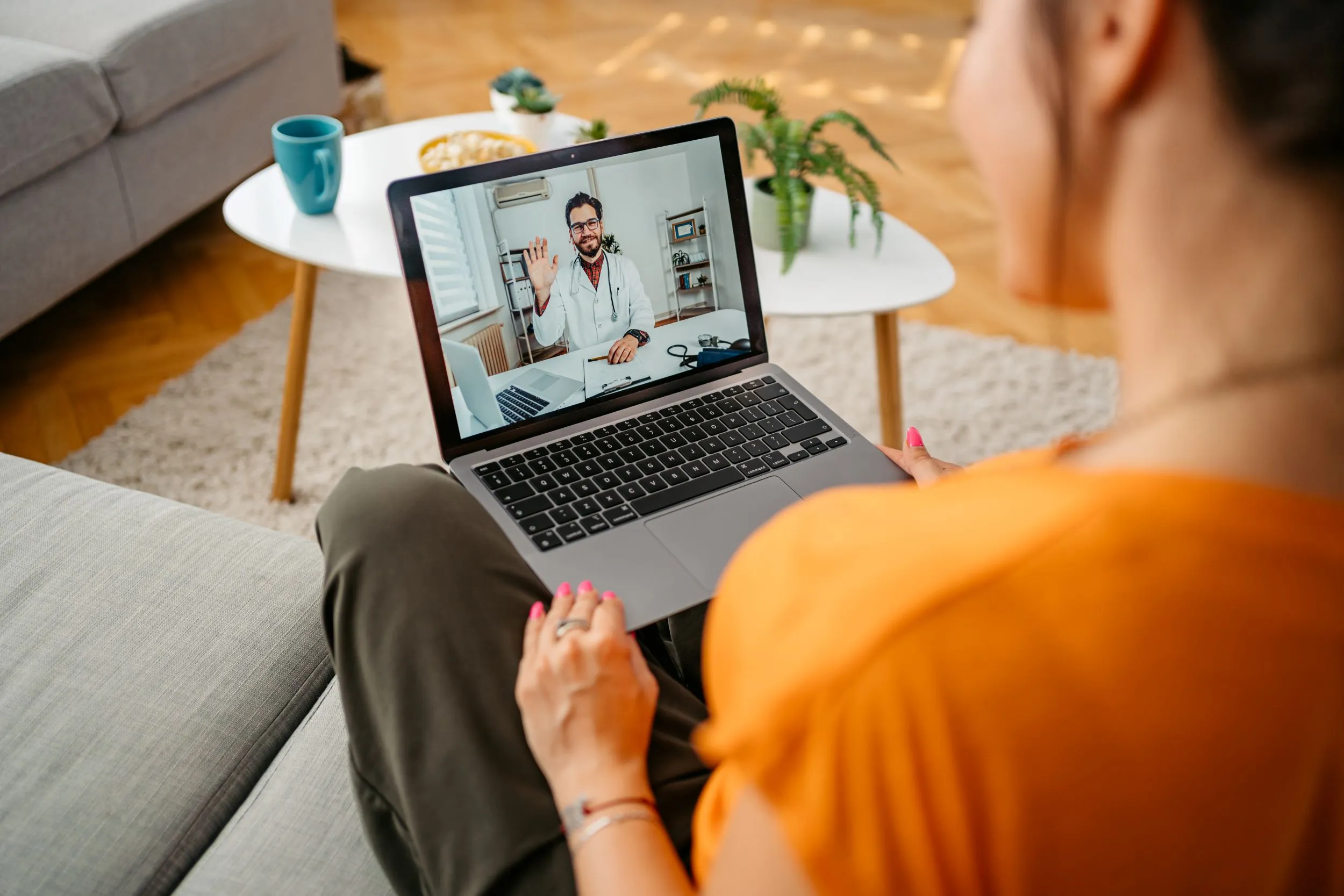 Person on laptop during a telehealth appointment 