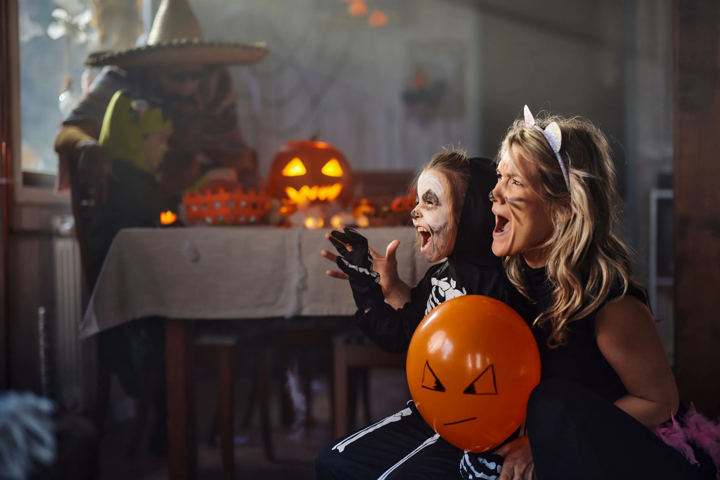 Mother and daughter having Halloween party fun