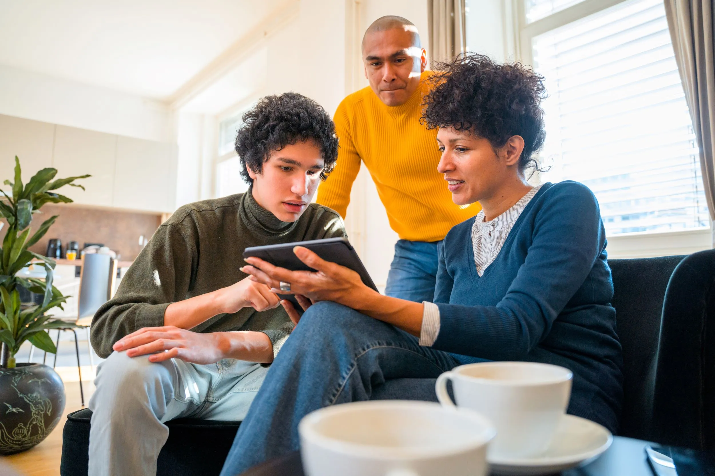 Parents with their son, going over their social media account