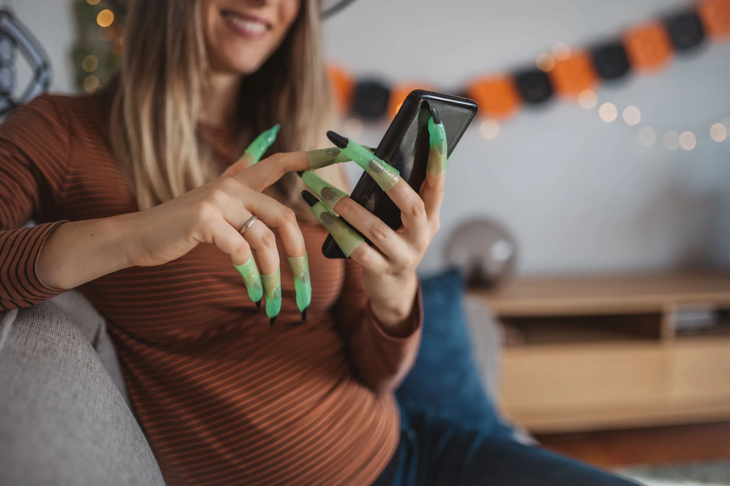 Lady with witches finger using mobile phone