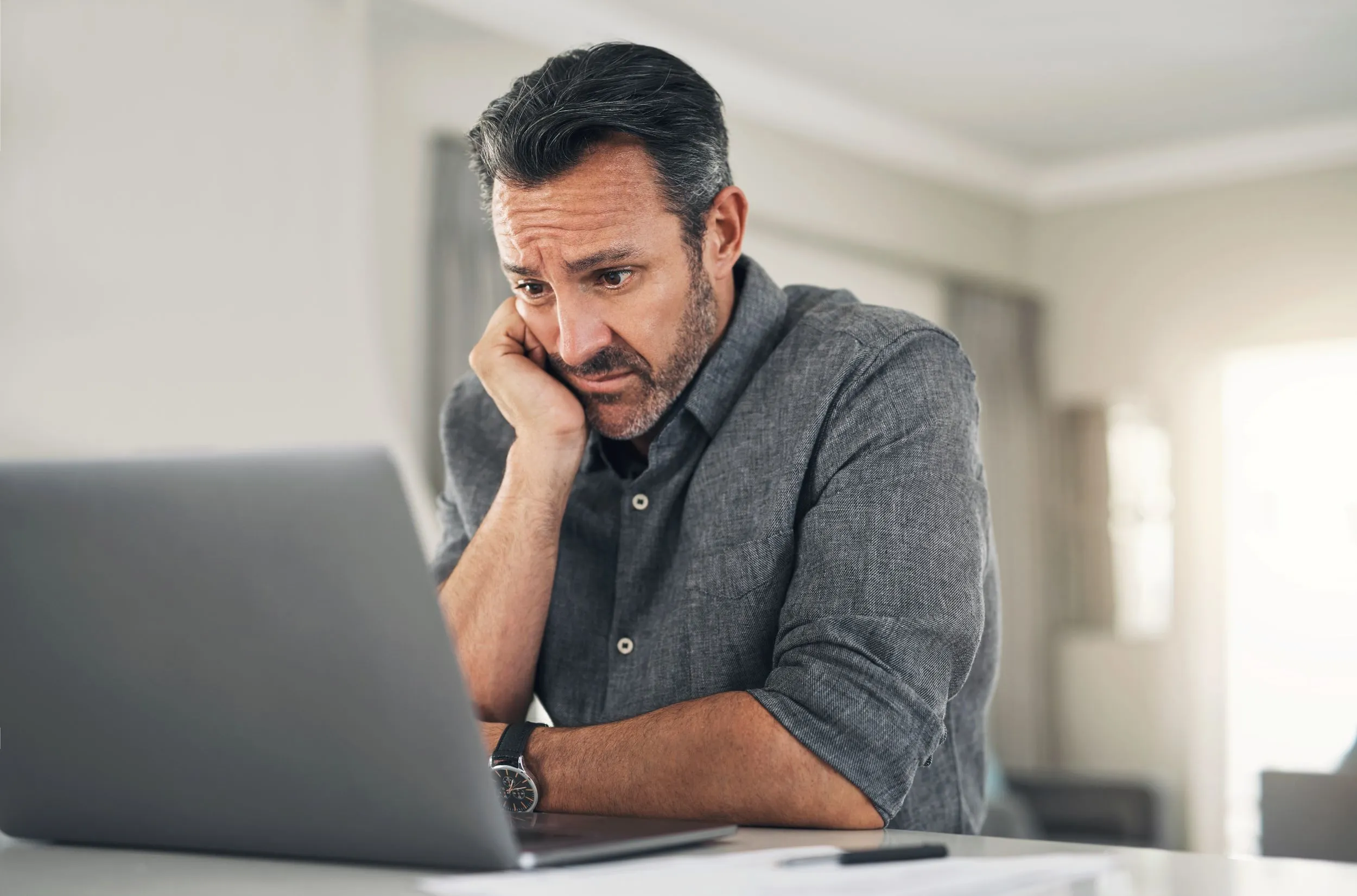 Man looking concerned at website