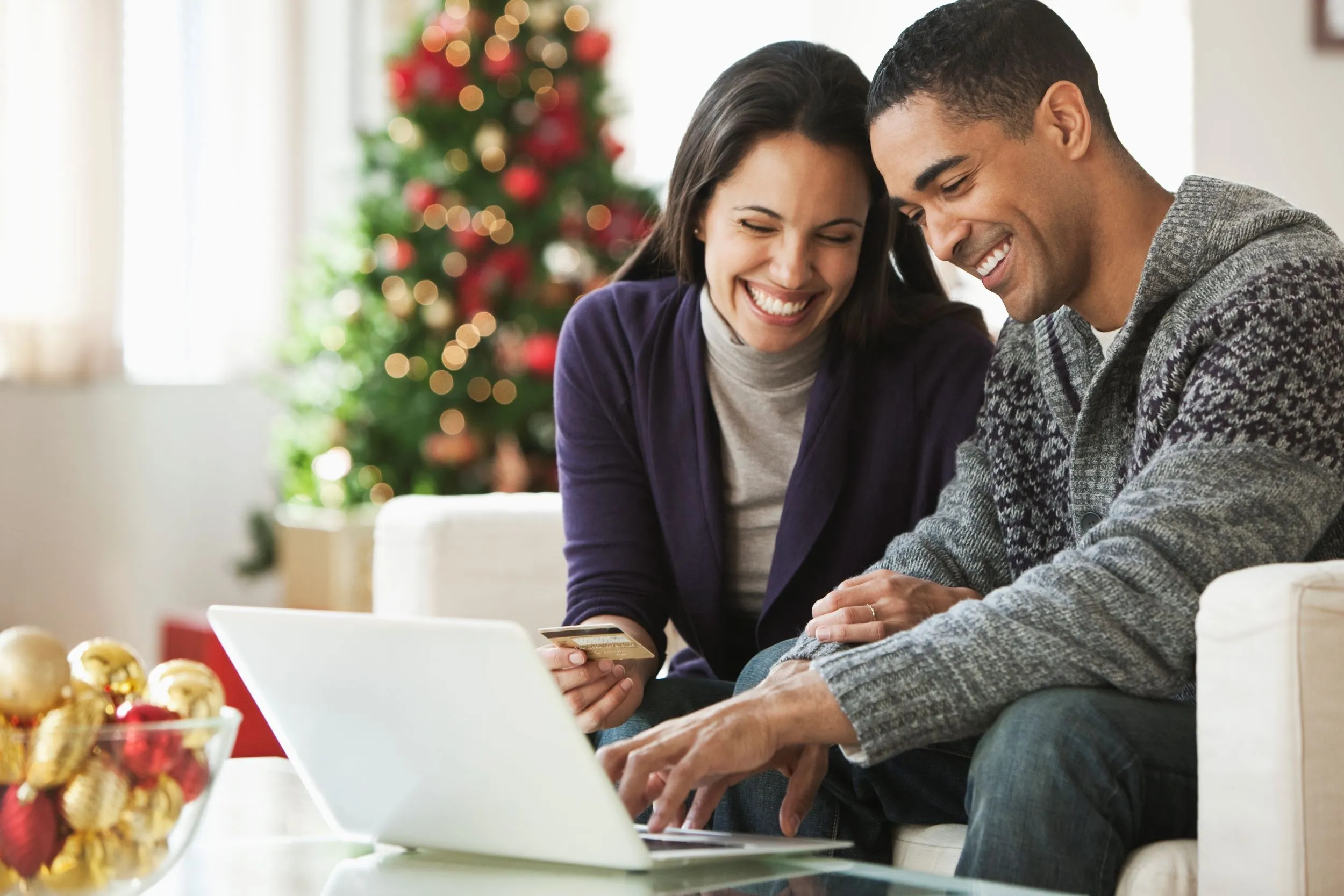 Couple buying gifts online at home together