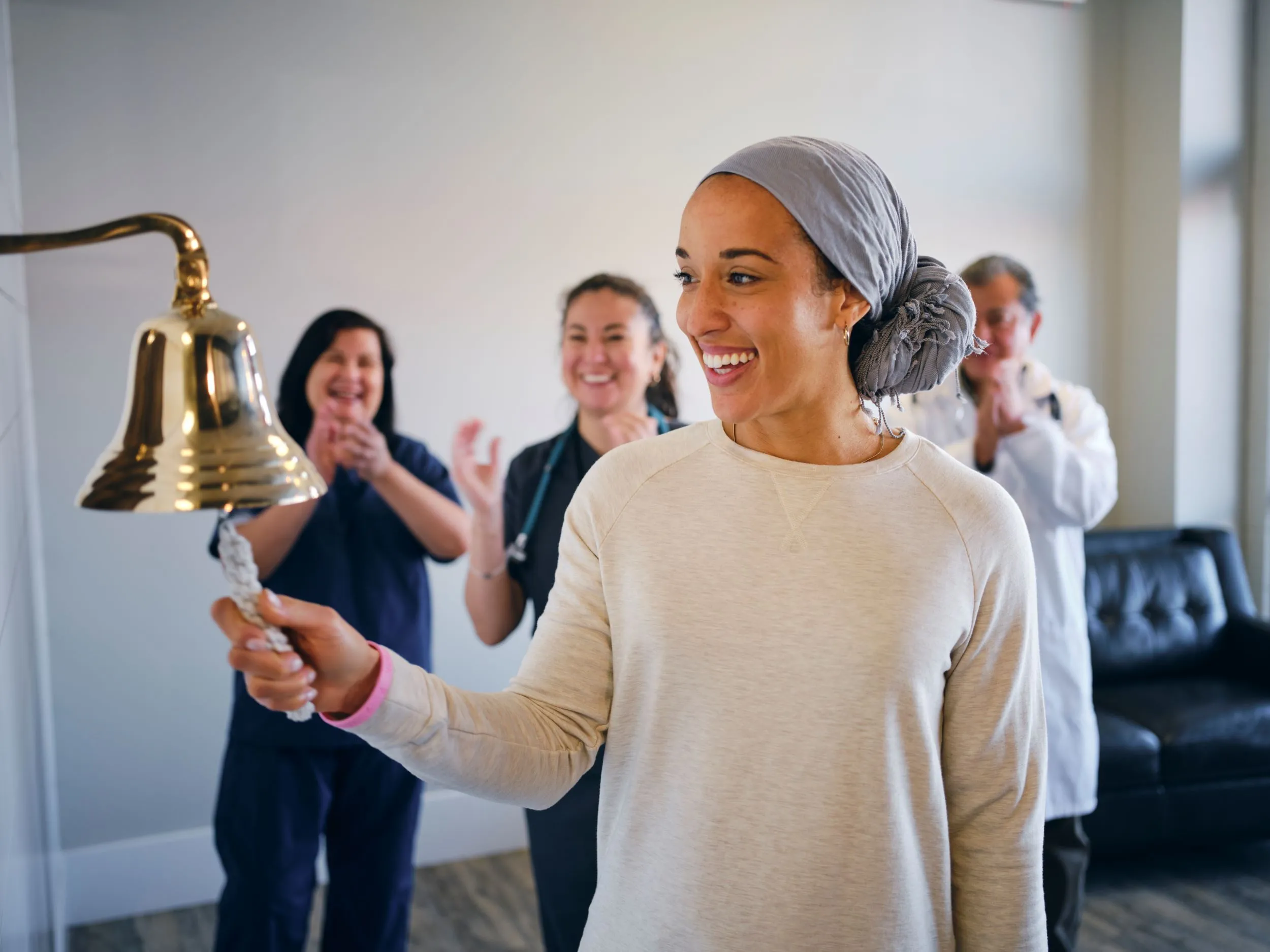 Women ringing the bell who completed cancer treatment