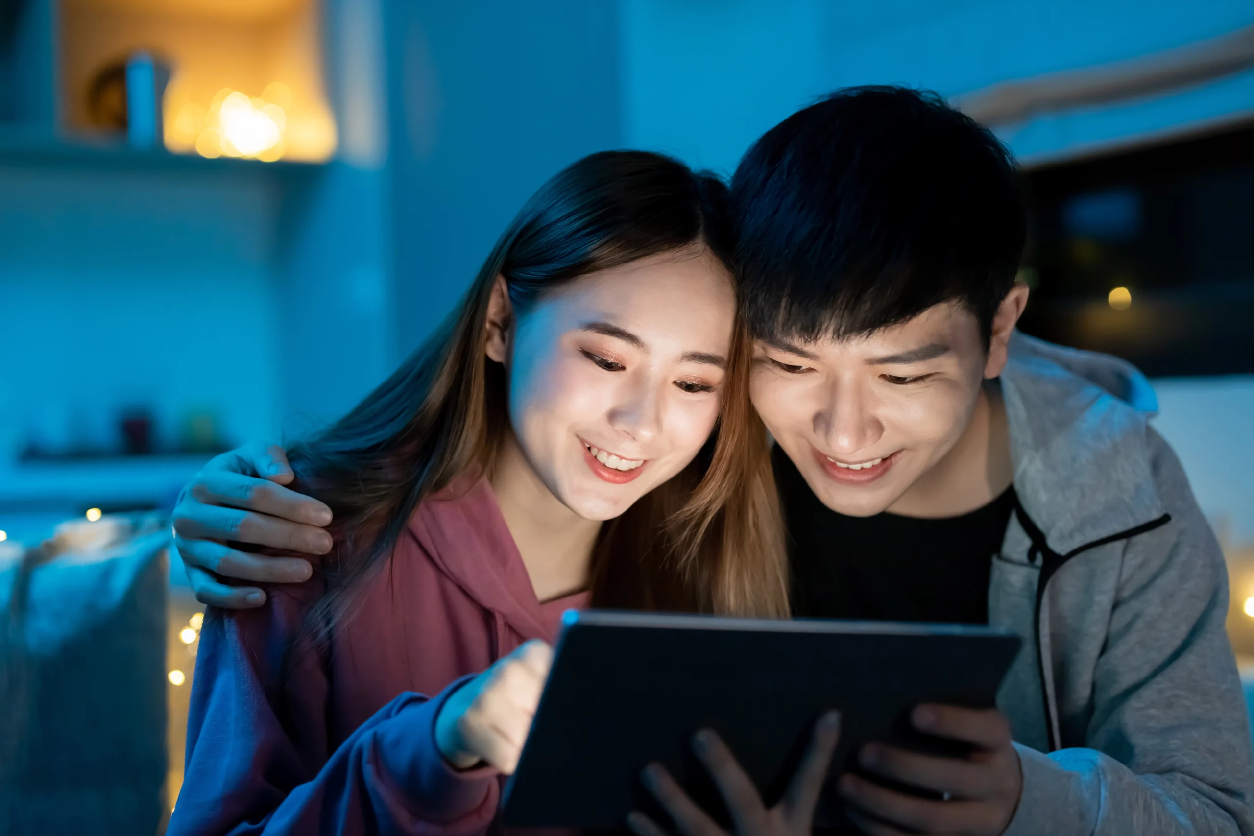 Couple streaming movie on tablet