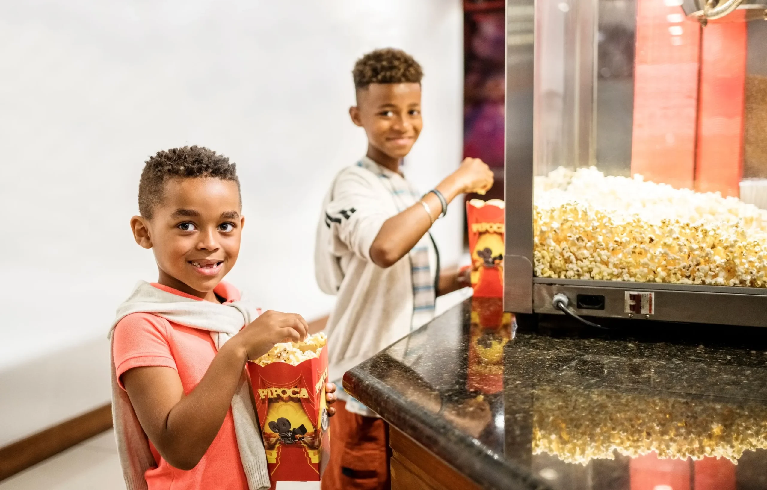 Kids getting freshly made home movie theater popcorn