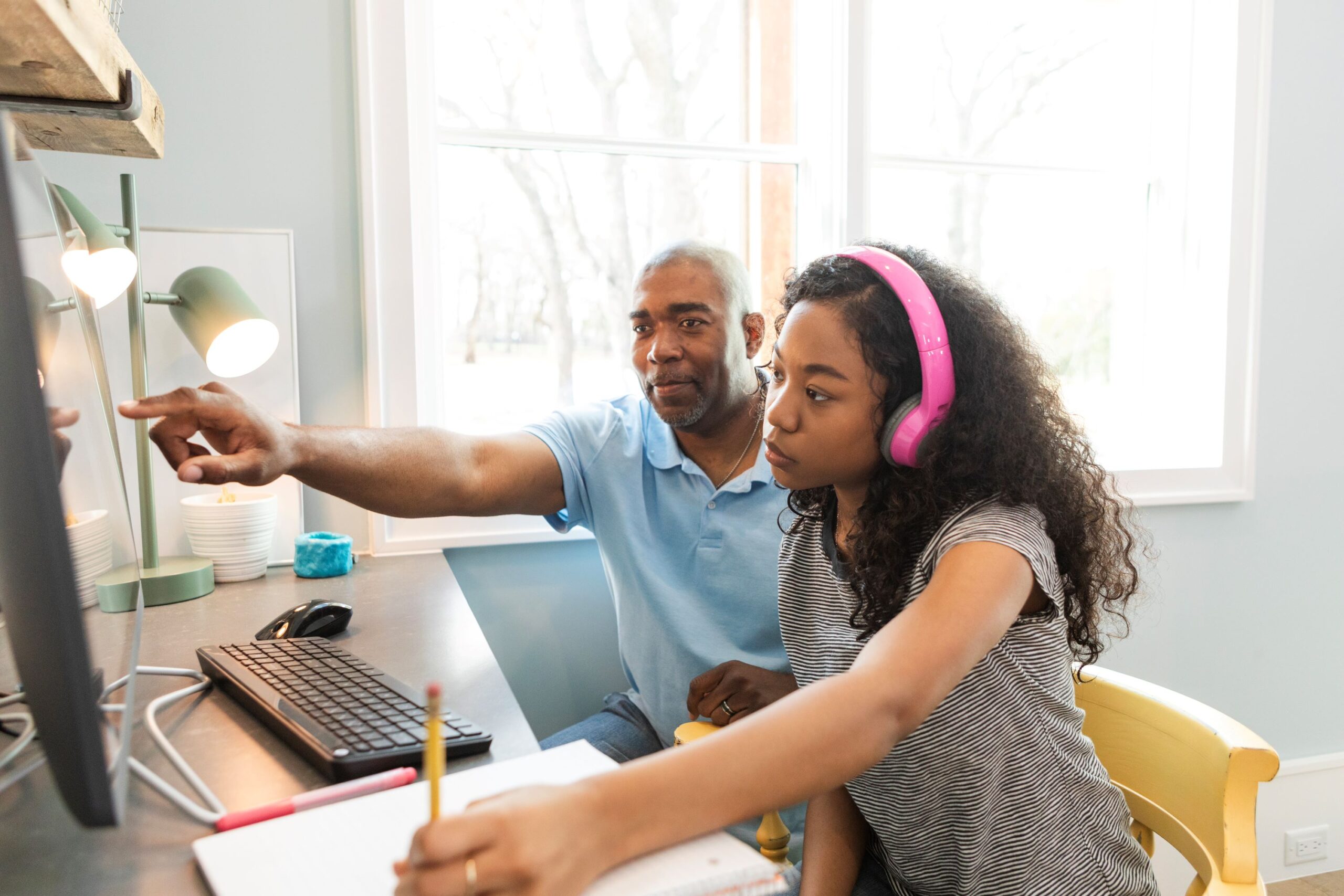 Dad and daughter doing school work at home Dad and daughter doing school work at home