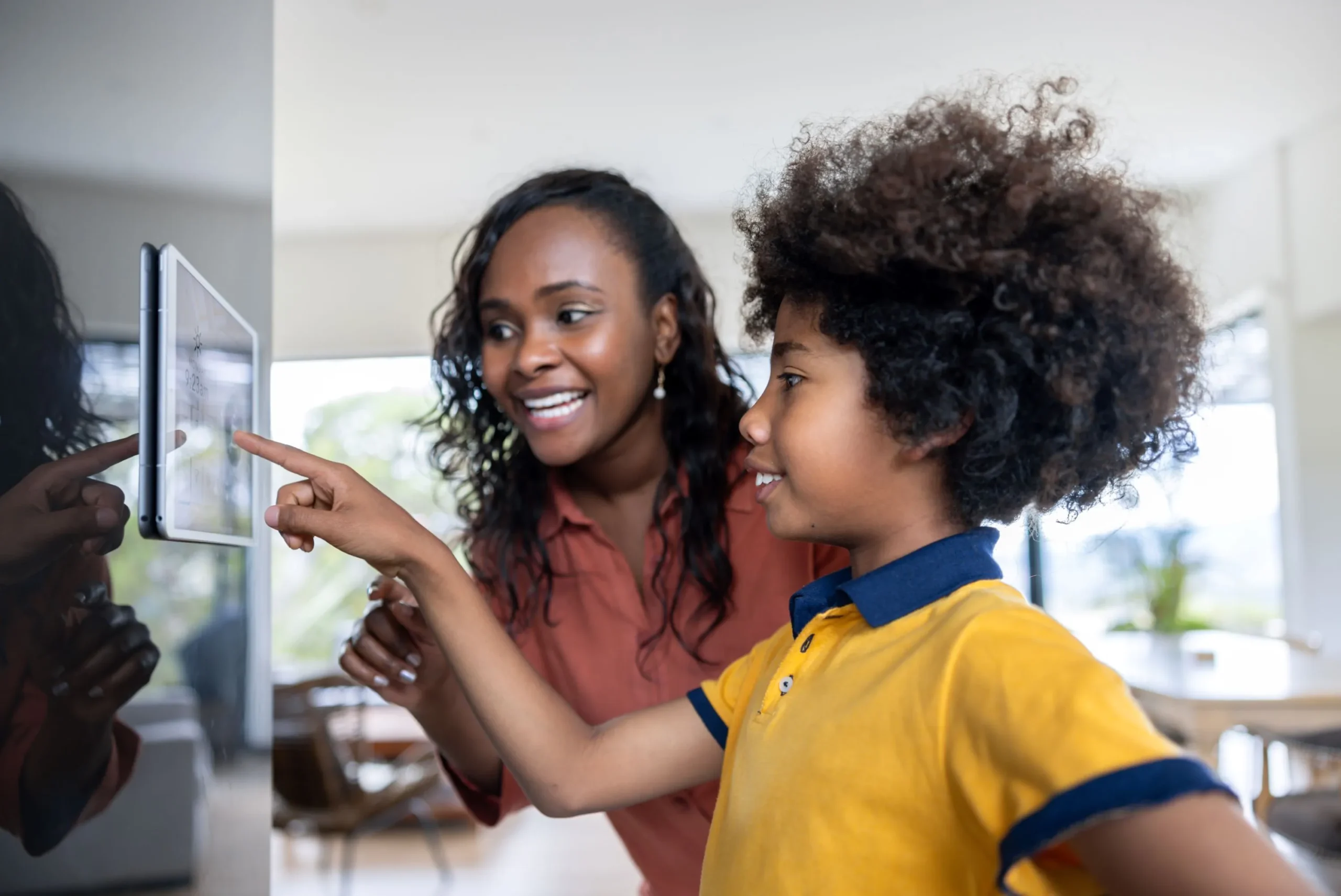 Mother with son checking the smart thermostat 