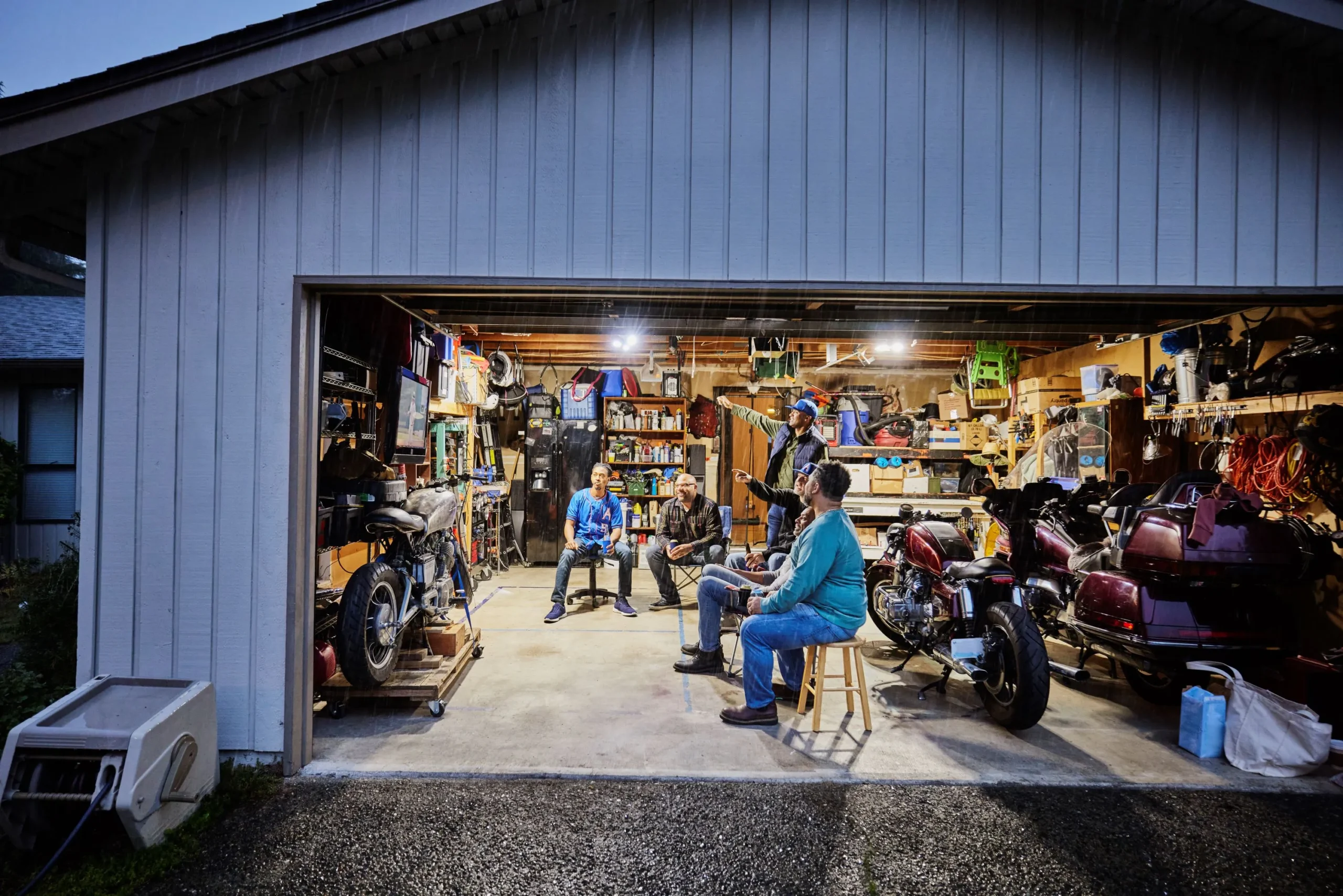 Men gathering in garage streaming sports tv Men gathering in garage streaming sports tv