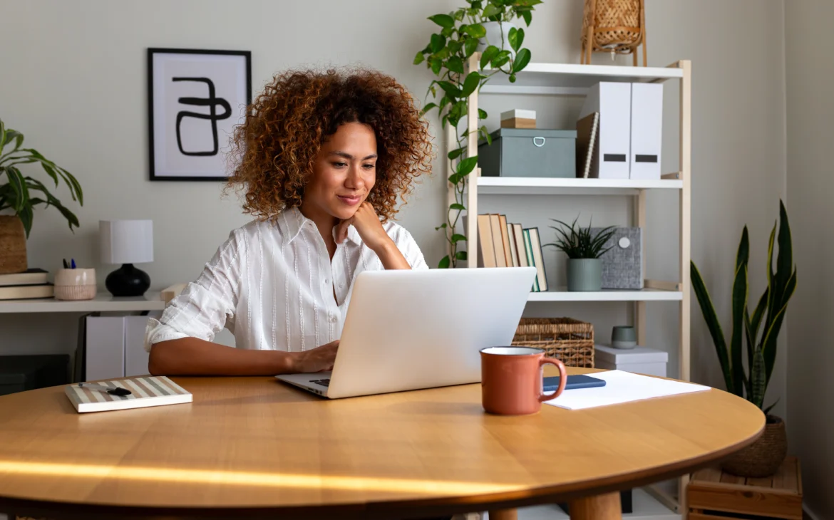 Woman sitting at table working on laptop
