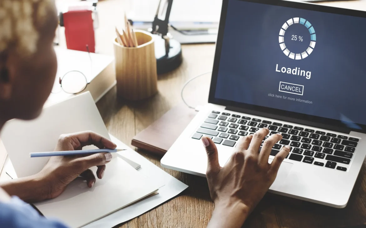 Woman looking at laptop screen loading