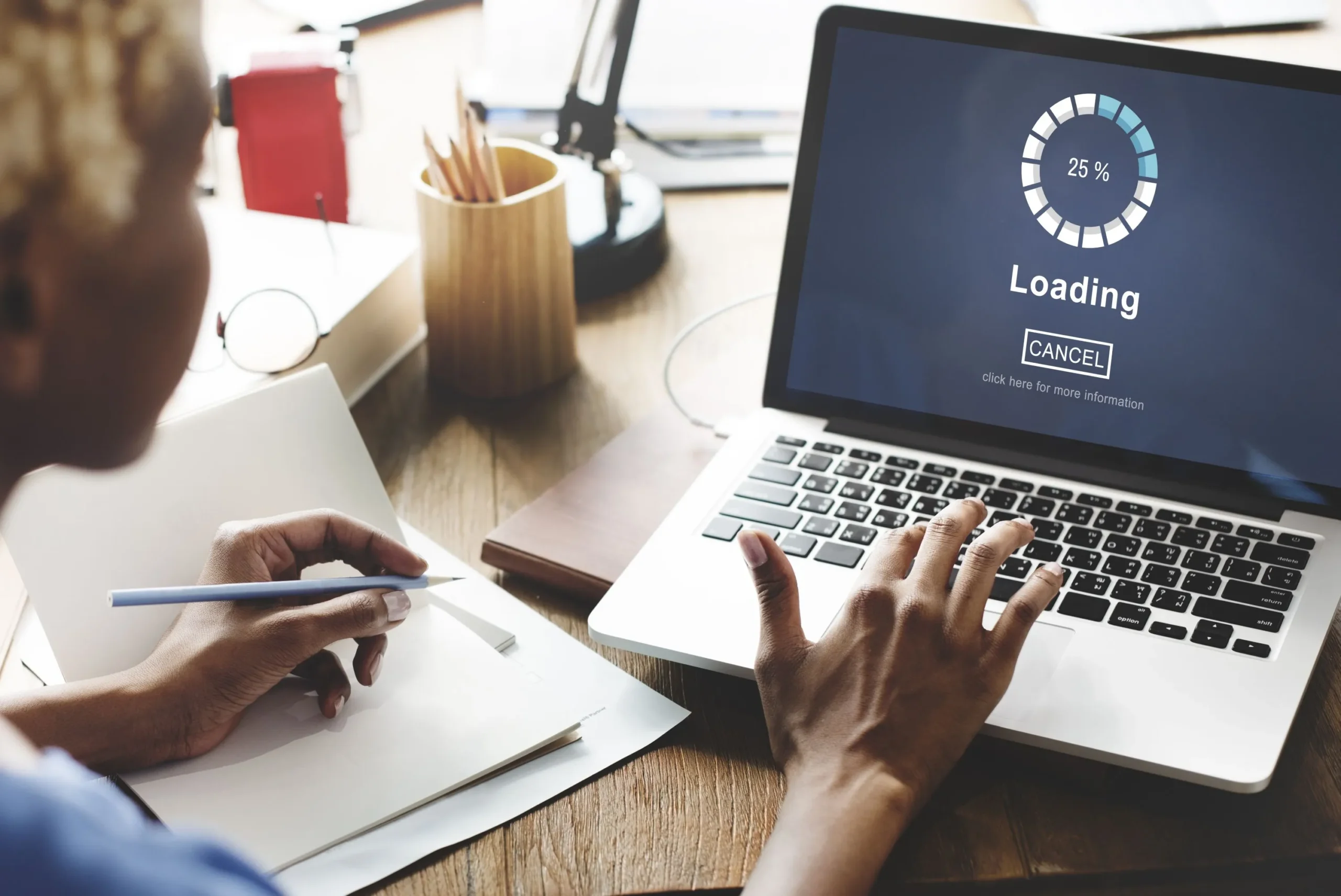 Woman looking at laptop screen loading