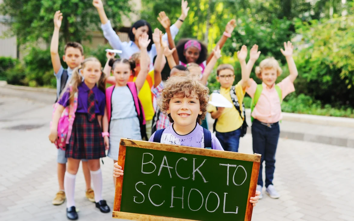 Group of kids with back to school sign