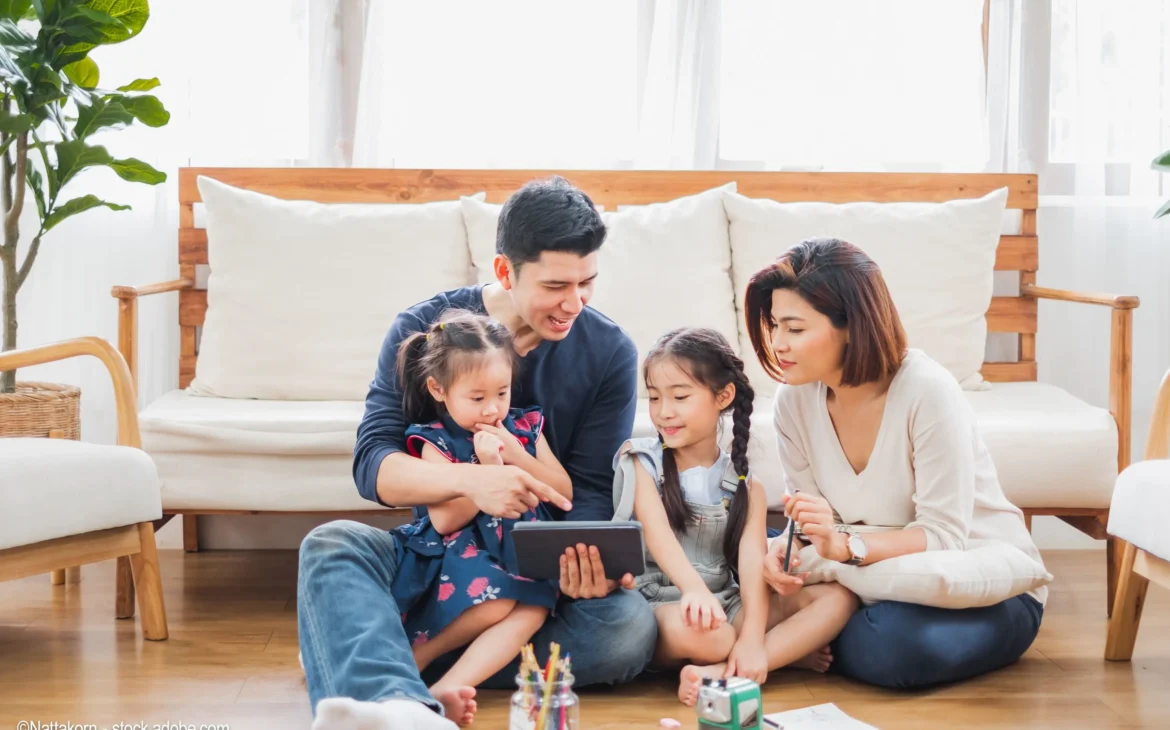family-sitting-together-on-device