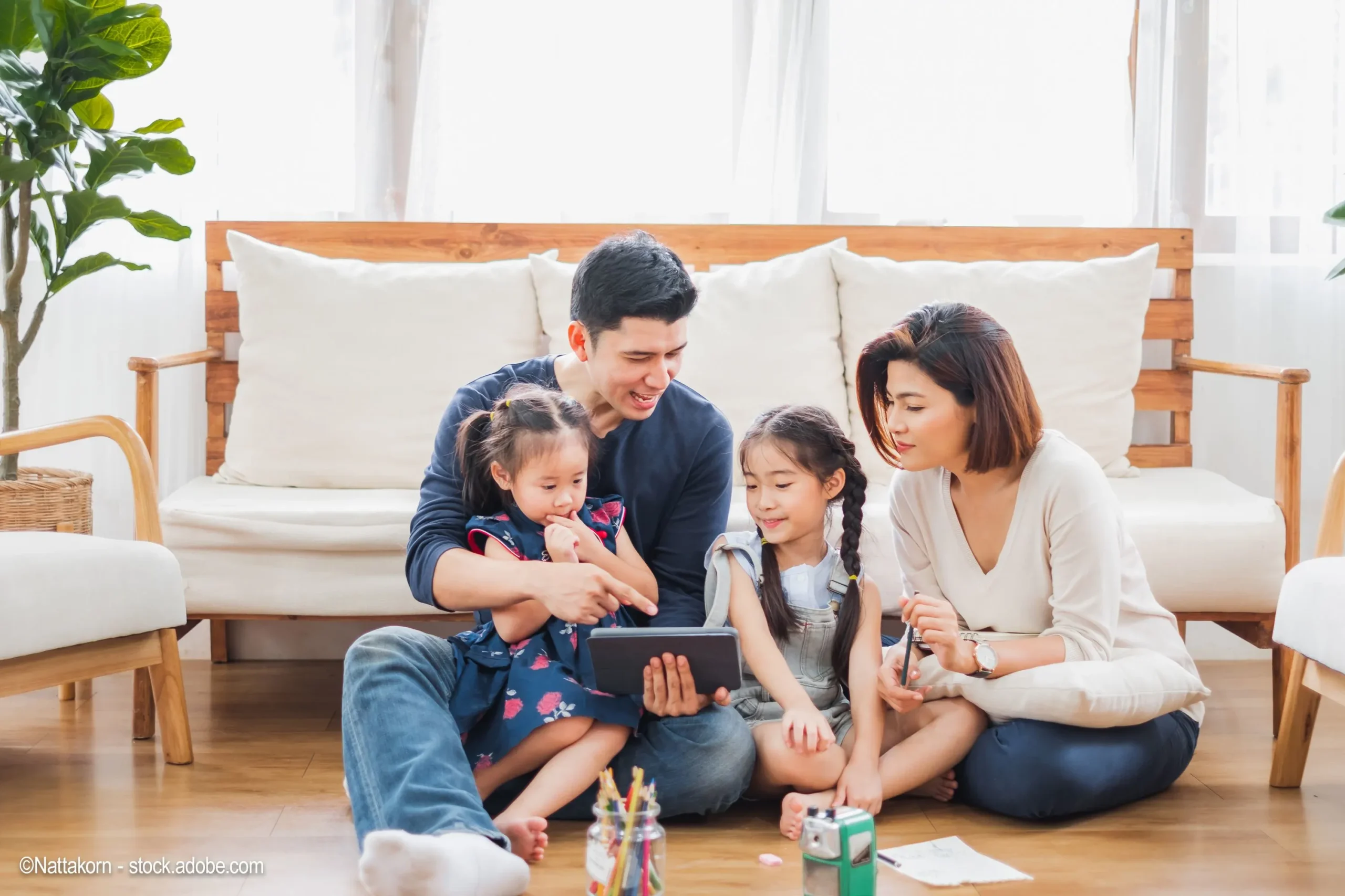 family-sitting-together-on-device