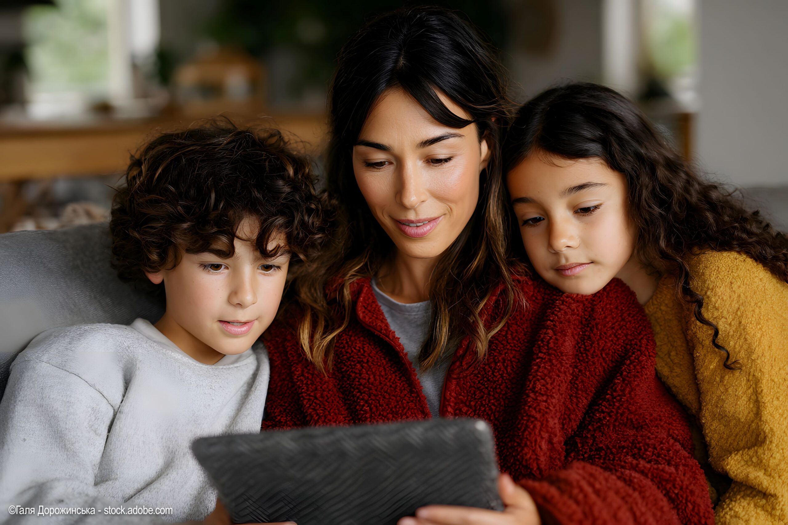 woman-and-children-looking-at-device
